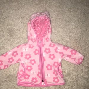 A pick jacket for 0-3 months it has a hood and ear
